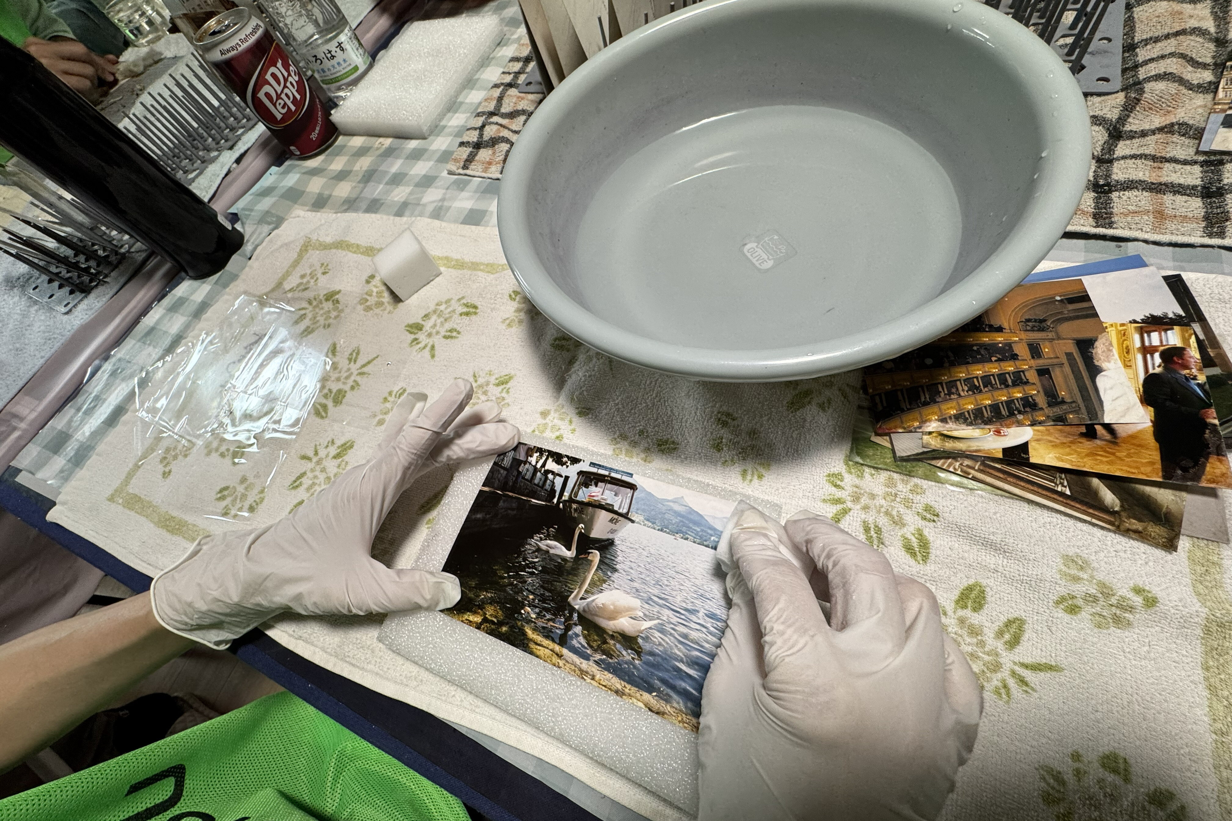 Carefully cleaning photos with a sponge